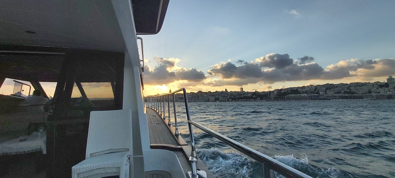 A boat cruising the Bosphorus during a sunset